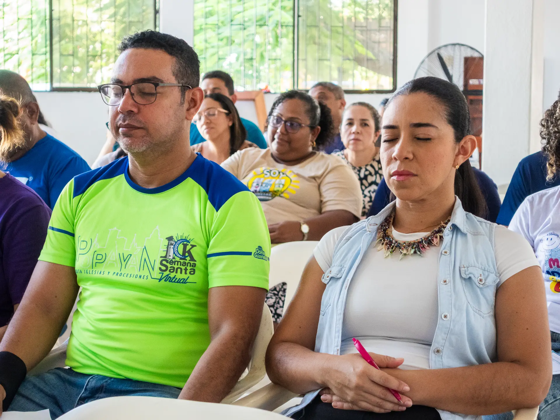 Couple praying among the congregation